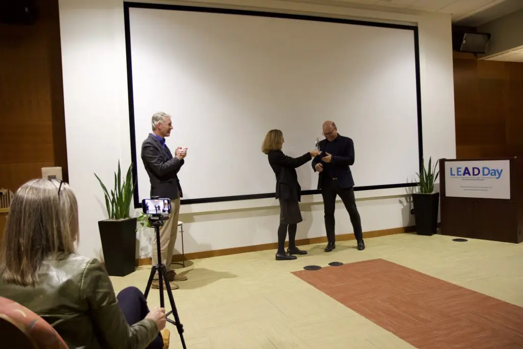 Sandy Boek Werness presenting LEAD Day award to Dr. Schett